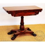 A William IV carved mahogany card table, with fold over top, on a baluster column,