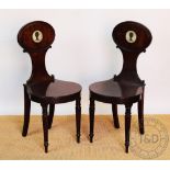 A set of four Regency mahogany armorial hall chairs,