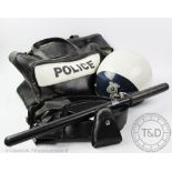 A Smith & Weston American Police Officers helmet, with a police bag and truncheon,