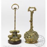 A Victorian brass door porter, designed with an anthemion base below a moulded stem,