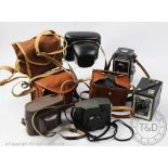 A collection of vintage 20th century cameras to include a Zeiss Ikon Ikoflex, a Cosmic 35 camera,