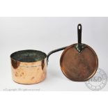 A 19th century copper and wrought iron handed saucepan and cover, initialled D.