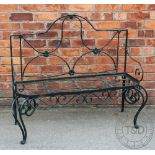 A painted metal garden bench, on scroll legs,