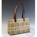 A ladies Burberry handbag, with tan leather straps,