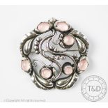 A Georg Jensen silver brooch, pattern 159, of stylised foliate form and set with pink quartz,