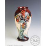 A large Moorcroft vase, decorated in a tulip pattern, designed by Sally Tuffin,
