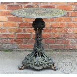 A cast iron garden table, with pierced foliate detailing,