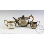 A George III silver teapot, marks worn, with a similar sugar bowl and jug, Sheffield 1936, 18.