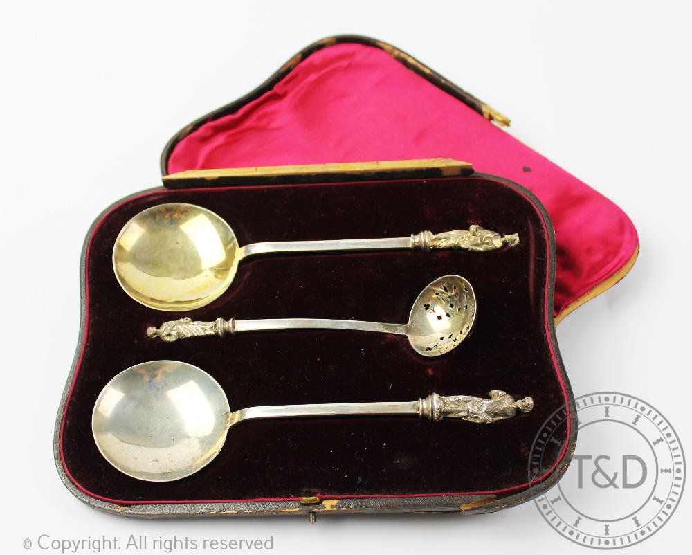 Military interest; A cased pair of silver Apostle serving spoons and a sugar sifter, Martin,