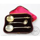 Military interest; A cased pair of silver Apostle serving spoons and a sugar sifter, Martin,