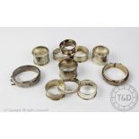 Nine assorted silver napkin rings, with two silver bangles, 6.
