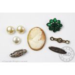 A selection of jewellery to include; a carved shell cameo brooch,