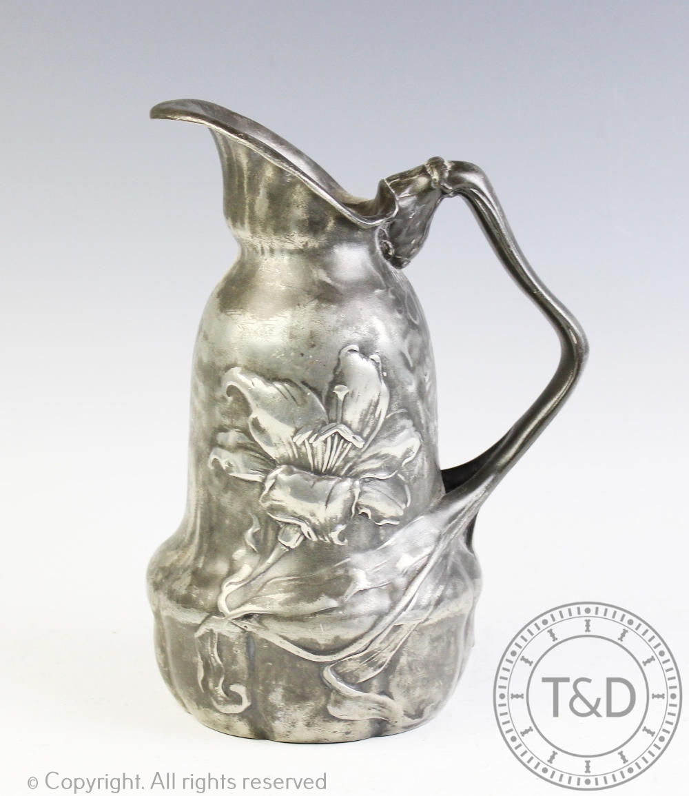 An Art Nouveau pewter ewer, of shaped form and cast with flowers,