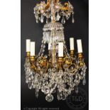 A French Louis XV style gilt metal and glass six light chandelier, c1900,