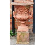 A large pair of reconstituted stone garden urns on stand,