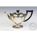 An assembled silver three piece tea service, comprising teapot and sugar bowl,