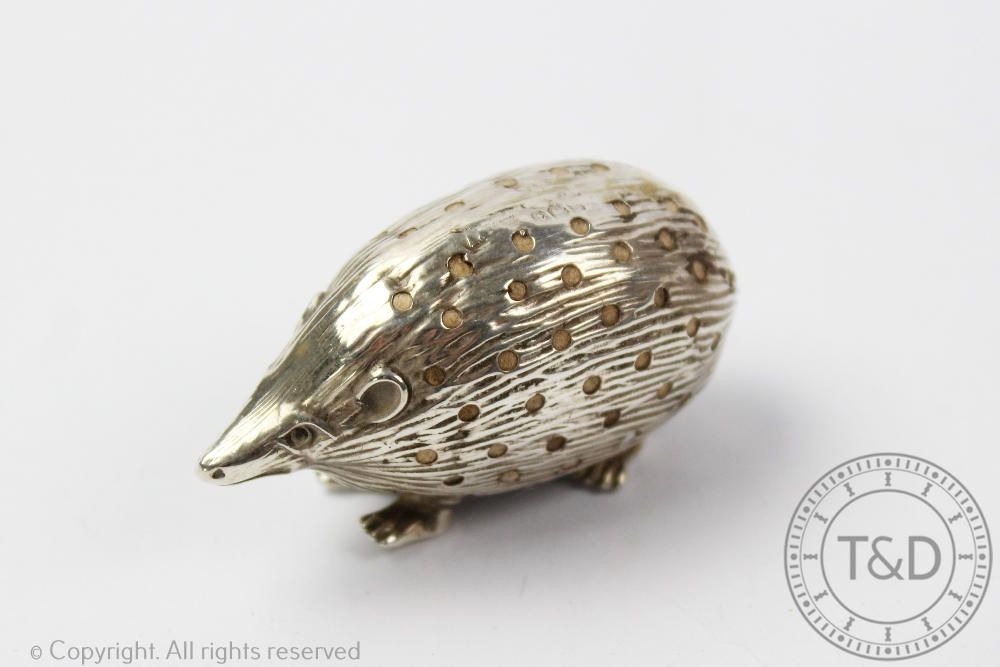 An early 20th century novelty silver pin cushion modelled as a hedgehog, 5cm long,