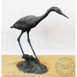 A 20th century bronze model of heron signed 'A.J.