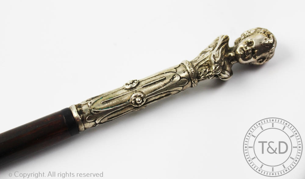 An early 20th century French walking cane, with white metal mount of an infant, - Image 2 of 2