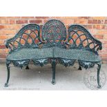 A Victorian style cast iron garden seat, of serpentine form, with pierced seat, 84.