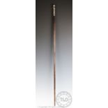 An early 20th century French walking cane, with white metal mount of an infant,