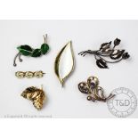 A collection of six brooches to include; a Flora Danika gold plated sterling silver leaf brooch,