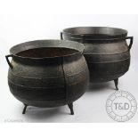 A pair of cast iron cauldrons, 30cm high (one with rim chip) Provenance: Clynog Farmhouse,