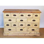 A modern Victorian style painted pine chest, with an arrangement of sixteen drawers,