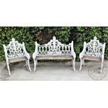 A Victorian style cast iron garden bench and two chairs, with foliate detailing and slatted seats,