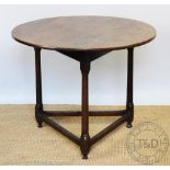 A late George III oak cricket table, early 19th century, with circular top, on turned legs,