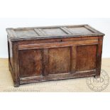 An early 18th century panelled oak coffer, on moulded stile feet, with three panelled front,