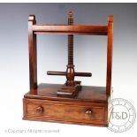 An early Victorian mahogany book press, with acorn finial and base drawer,