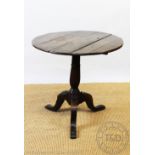 A George III oak tilt top occasional table, on tripod base,