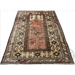 A Turkish Milas wool carpet, worked with a traditional geometric design against a washed ground,