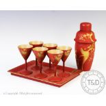 A Chinese lacquered cocktail set, comprising; six cocktail cups, a cocktail shaker, 20.