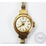 A ladys 9ct gold wristwatch, the circular dial signed 'J W Benson London',