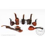 Seven carved novelty smoking pipes,