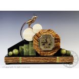 An Art Deco marble, onyx and bronze eight day mantel clock,