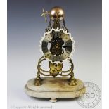 A brass skeleton mantel clock,