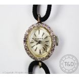 A 14ct gold and diamond Benrus cocktail watch, the oval dial with diamond set bezel,