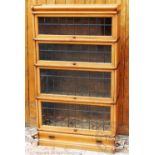 A Globe Wernike oak four section bookcase, with lead glazed doors and base drawer,