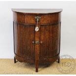 A Dutch oak bow front cabinet, c1800, with drawer and two tambour doors, on shaped feet,