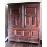 An 18th century oak livery cupboard, with two fielded panel doors enclosing original hanging pegs,