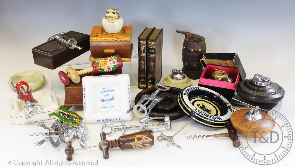 A collection of smoking ephemera to include vintage advertising ashtrays, novelty table lighters,