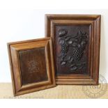 A carved wood panel decorated with fruiting vines, in an oak cushion frame, 83cm x 63cm,