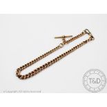 A 9ct yellow gold Albert chain, the graduated curb link albert with attached T bar and swivel,