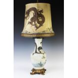 A Chinese crackle glaze lamp, moulded with a dragon and a carp, with an embroidered shade,