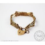 A yellow metal gate type bracelet, the articulated gate bracelet with attached padlock clasp,