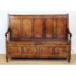 A George III Welsh oak settle, probably Carmarthenshire, with five panelled back,