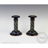 A pair of Royal Doulton stoneware candlesticks, with spiral columns and swag details,